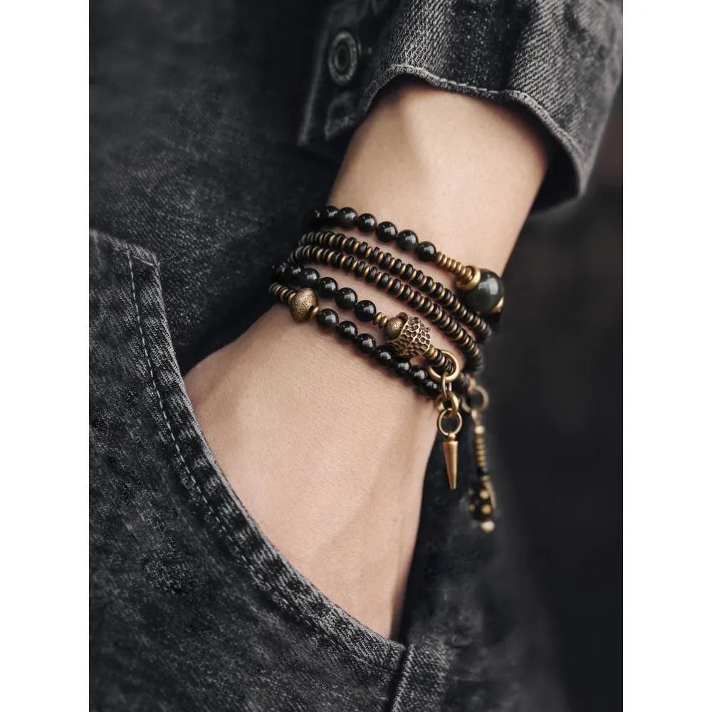 Black multi-layered beaded bracelet with geometric shapes showing natural style design