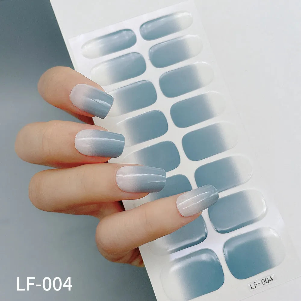 Set of 16 solid colour full nail art stickers showing patterns like cross, rose, tulip, and cartoon designs.