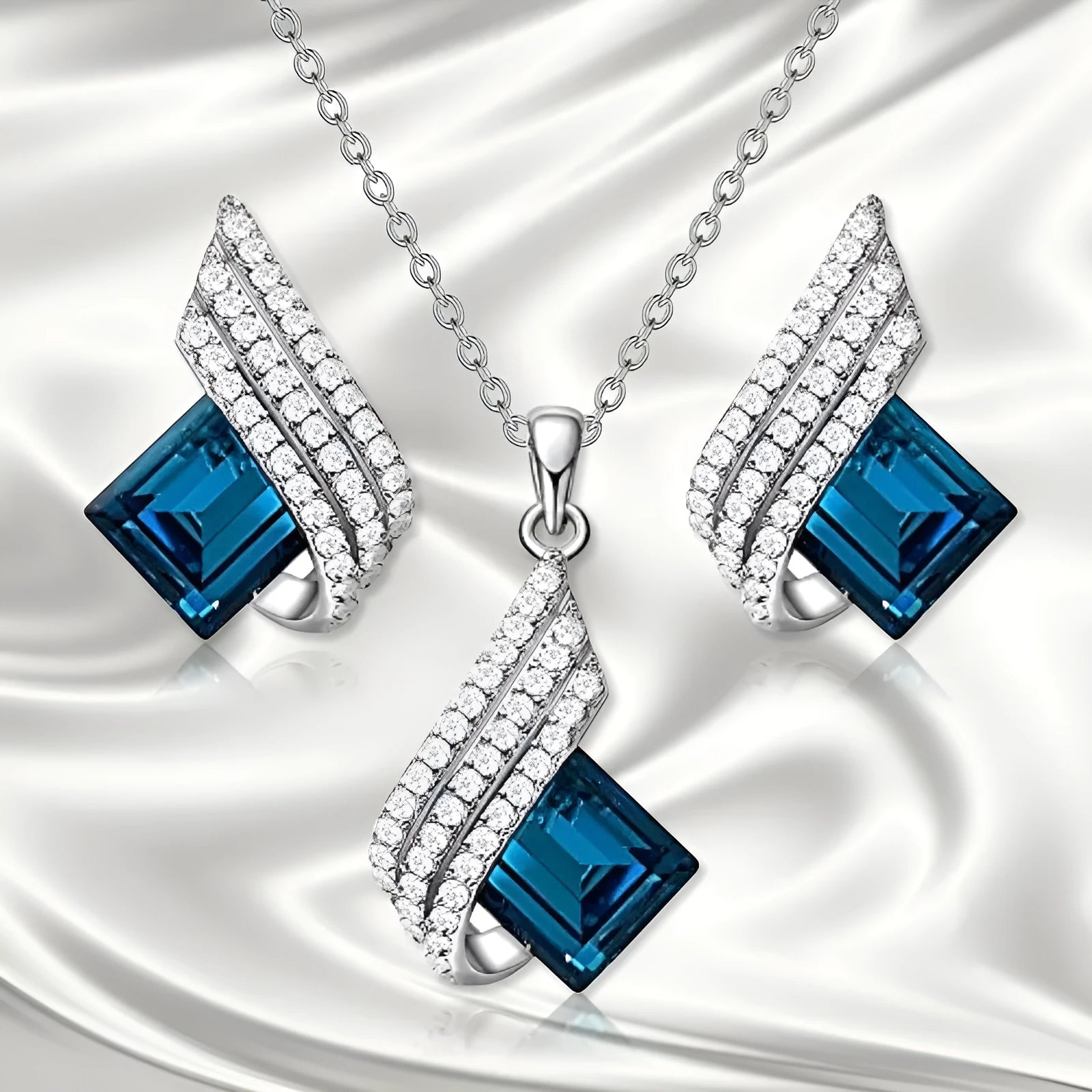 Glass pendant on an alloy cross chain necklace with matching ear studs, in two colour style options.