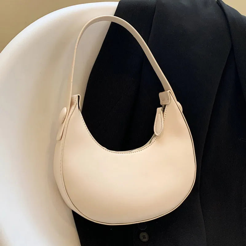 Women's retro-style PU shoulder bag in a dumpling shape, shown in one of four colours: black, cream yellow, brown, or white.
