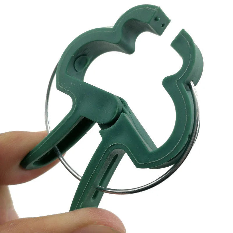 Green plastic and zinc plant fixing clips for supporting climbing beans and tomatoes.