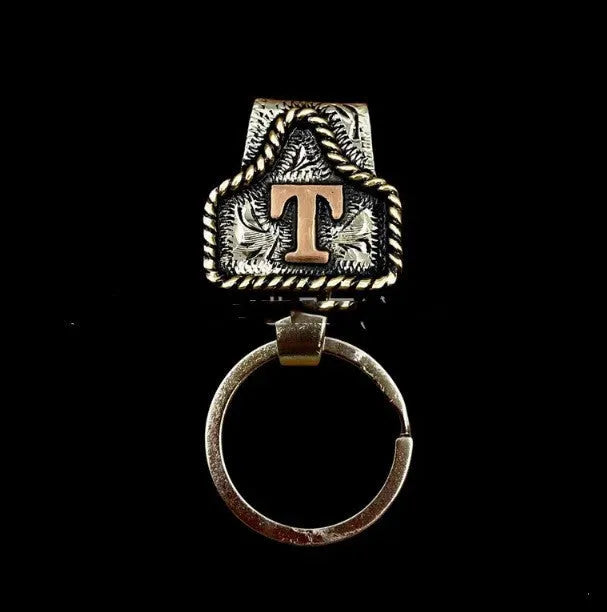 Handmade metal keychain with a cow tag charm in one of 26 available colour options.