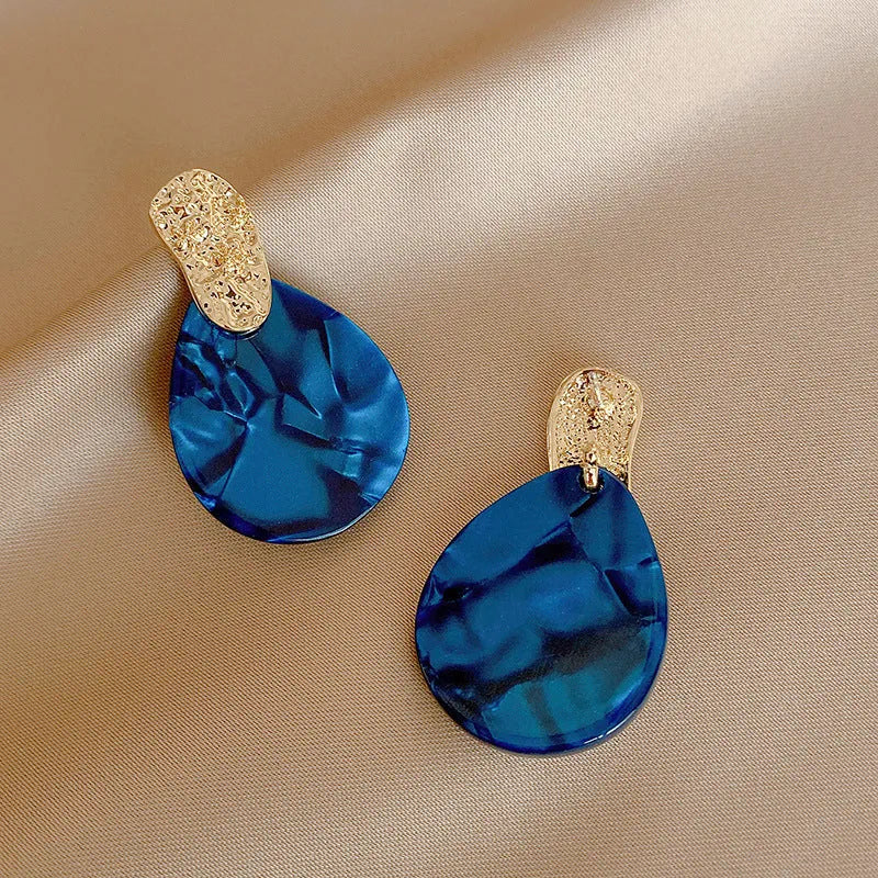 Silver Needle blue acrylic water drop ear studs with pleated texture on white background