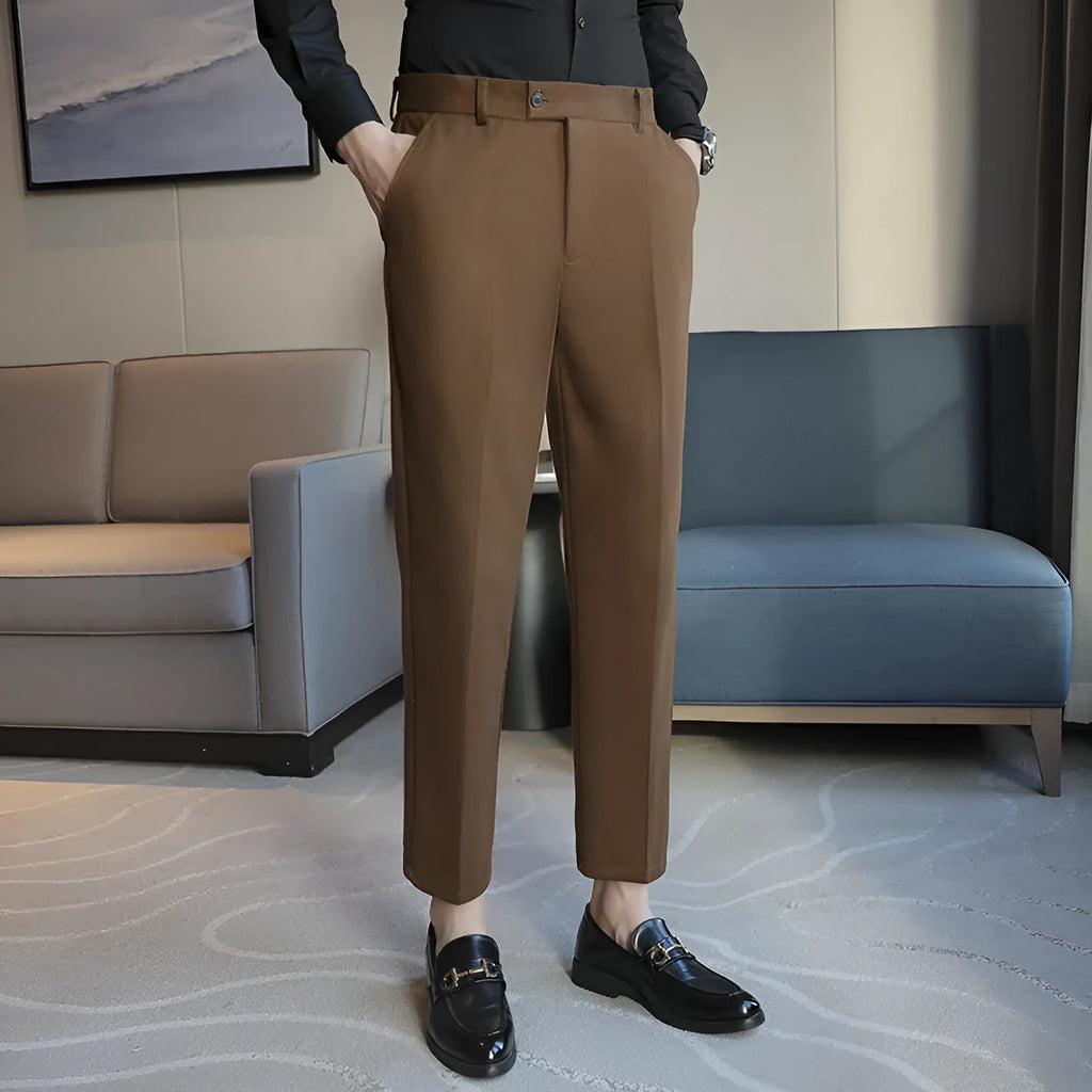 Retro brown straight leg corduroy trousers with elastic waistband laid flat.