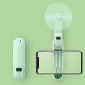 Green folding mini fan with plastic leaves, shown open and closed to show compact design.
