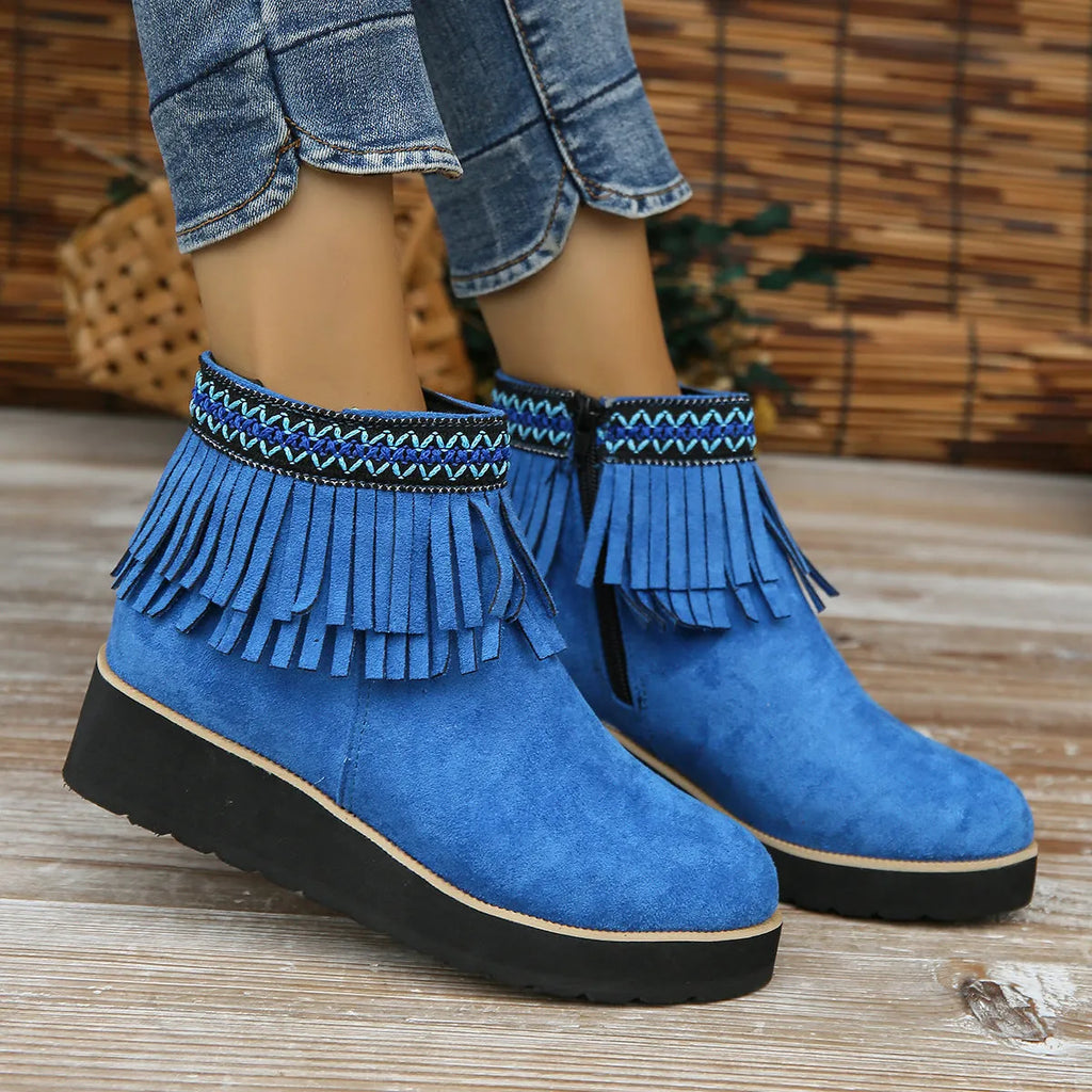 Women's dark brown suede wedge bootie with side zip, tassel detail, and thick rubber sole