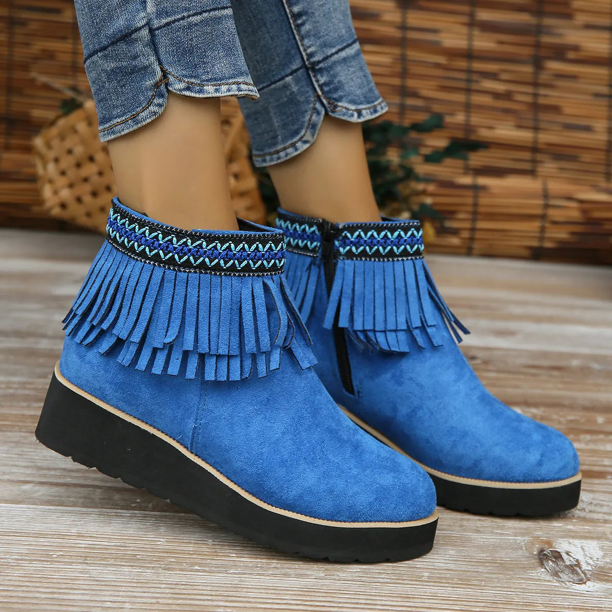 Women's dark brown suede wedge bootie with side zip, tassel detail, and thick rubber sole