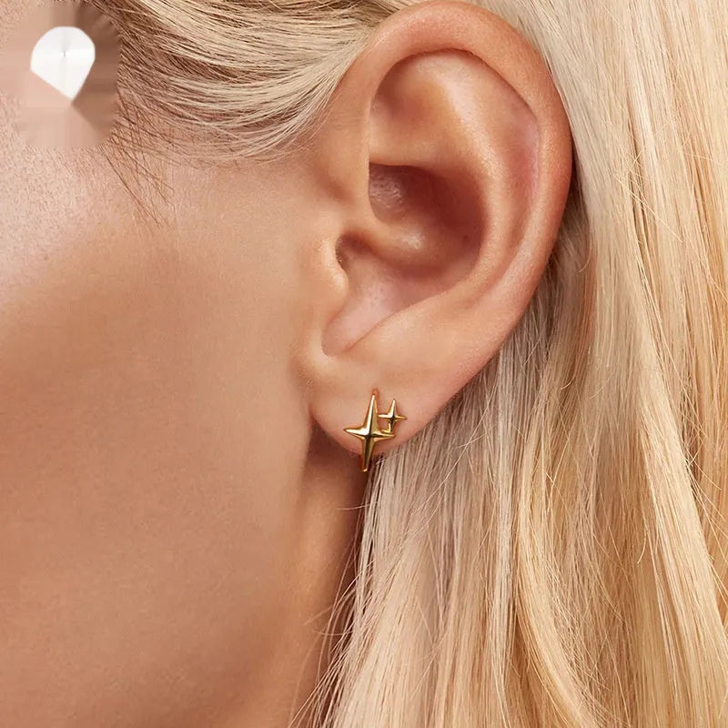 Minimalist star design sterling silver clip-on earring with XINGX motif.