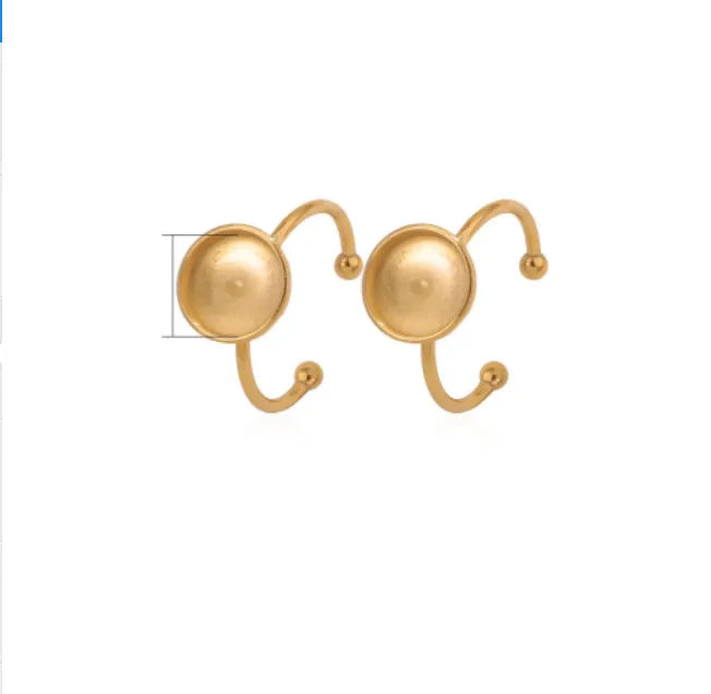 Assortment of golden stainless steel DIY jewellery settings in oval, heart, round, square, and rectangle shapes with totem pattern.