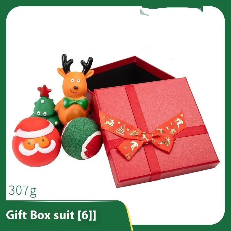 Christmas-themed vinyl dog toys including barbell, ball, rope, and Santa designs in gift packaging
