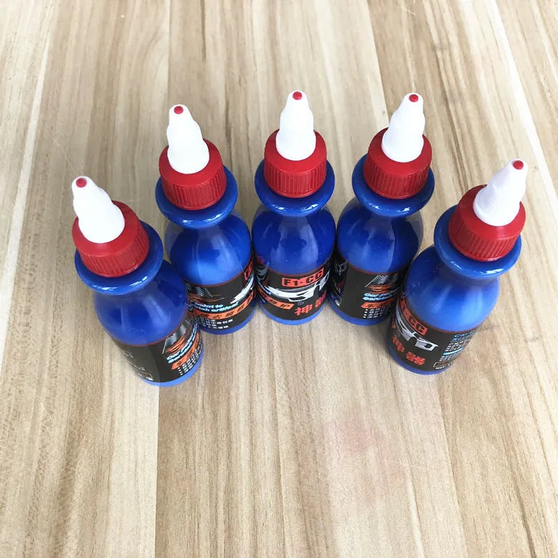 Small blue container of car scratch repair agent with sponge applicator for vehicle paint touch-ups