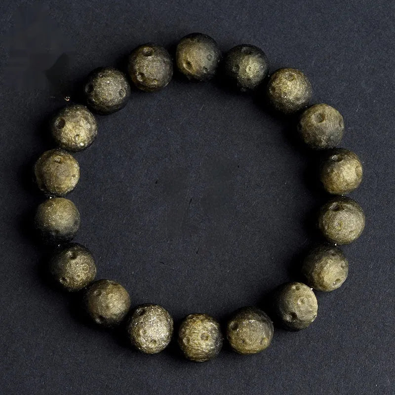 Natural obsidian crater ball bracelet with polished beads in silver or golden meteorite colours