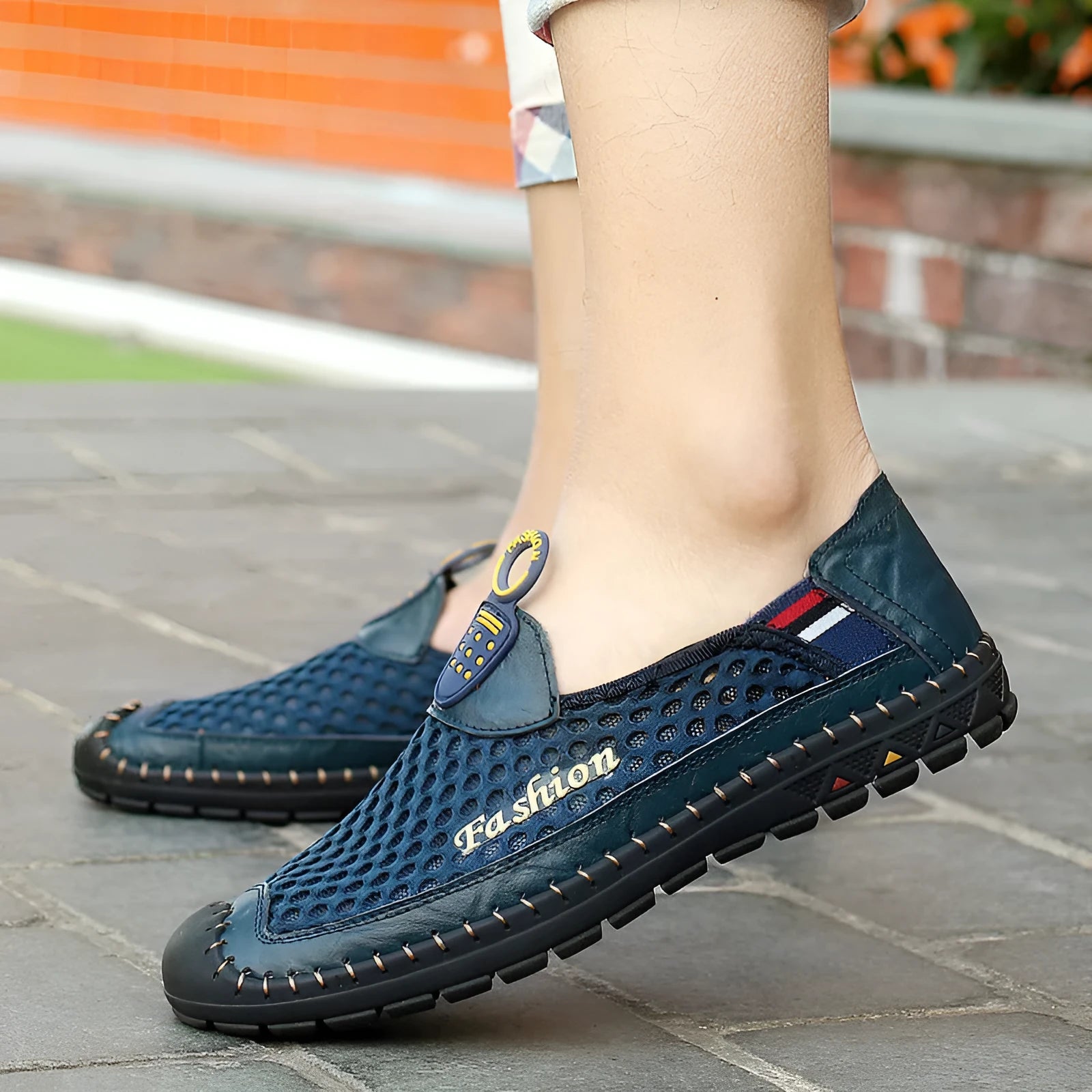 Men's brown mesh casual shoes with round toe and rubber sole on a plain background.