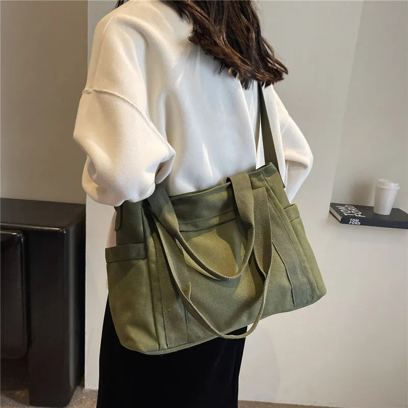 Polyester shoulder bag in solid colour with sandwich pocket and phone compartment