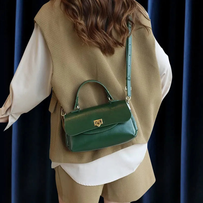 Women's dark brown genuine leather saddle back handbag with multiple compartments and shoulder straps