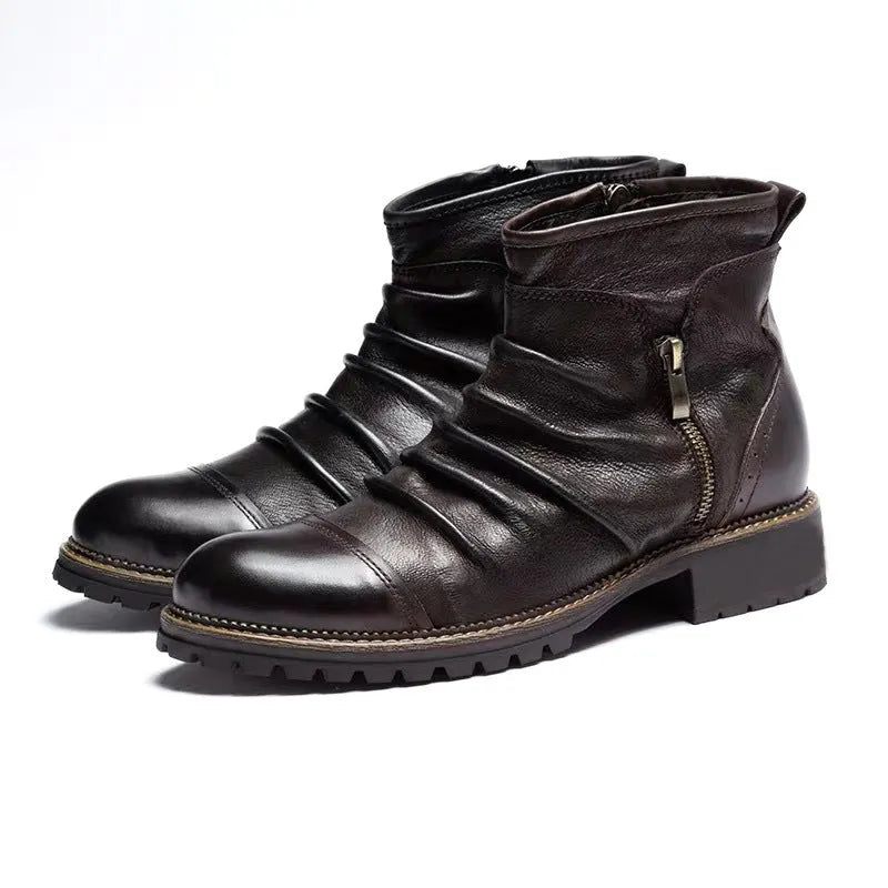 Men's black side-zip cowboy boots with a round toe and horseshoe heel on a wooden floor.