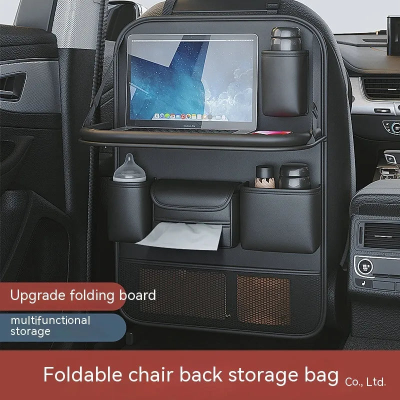 Car seat lazyback storage bag in Obsidian Black with foldable dining table extended, hanging on a car front seat backrest