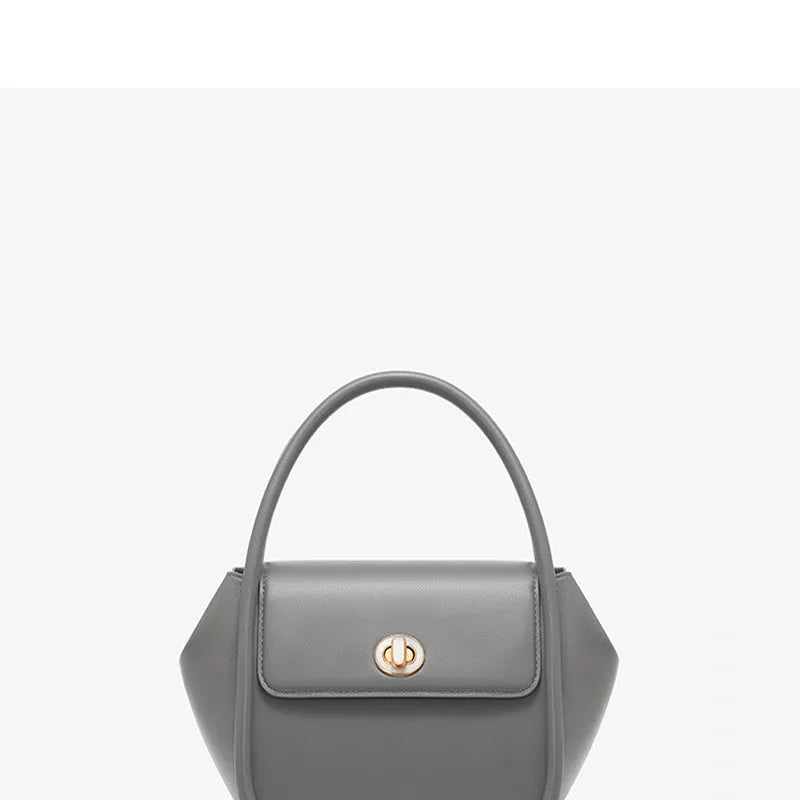Women's leather wing-shaped tote bag with buckle closure in blue, grey, black, or brown colour options