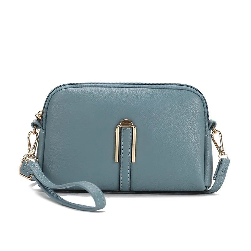 Women's solid colour PU messenger bag with stitching details and shell shape