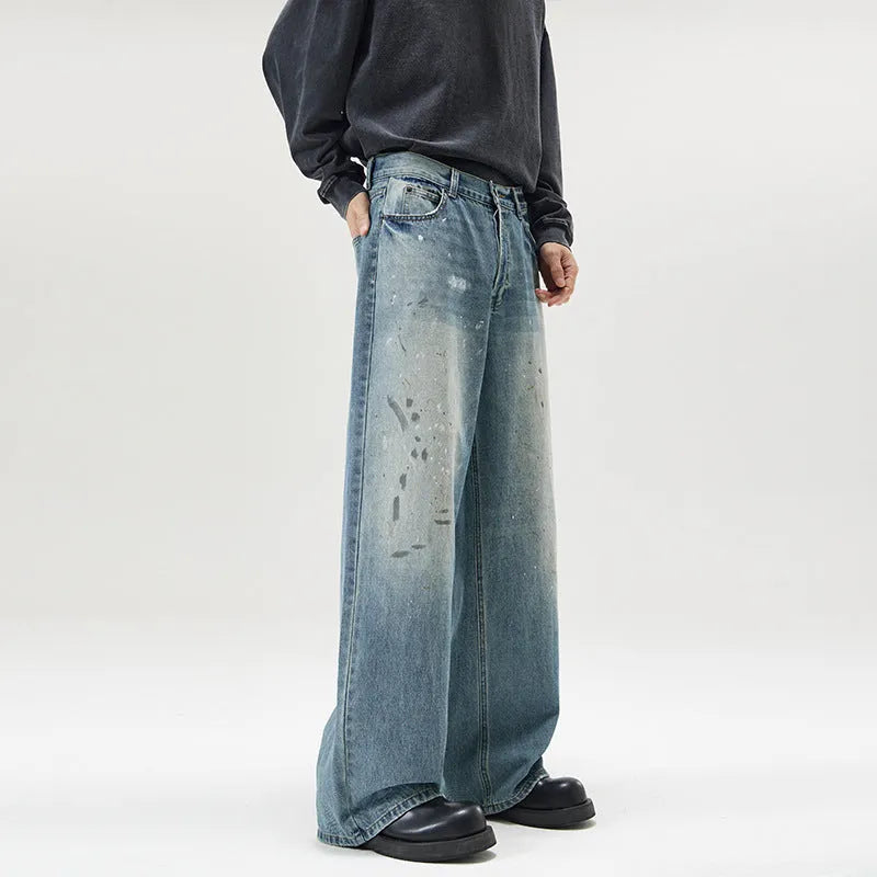 Men's loose fit splash-ink washed denim jeans in Ice Blue on a model, front view