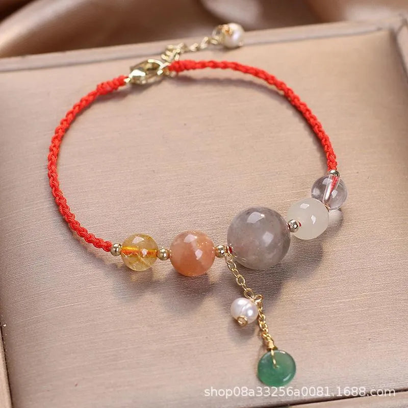 Women's hand-woven bracelet with peace buckle closure and crystal sequins in red, green, and blue colour options