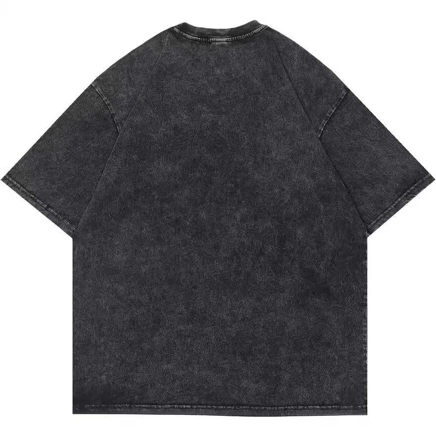 Man wearing a loose-fit black T-shirt with a colourful cartoon print on the front, short sleeves.