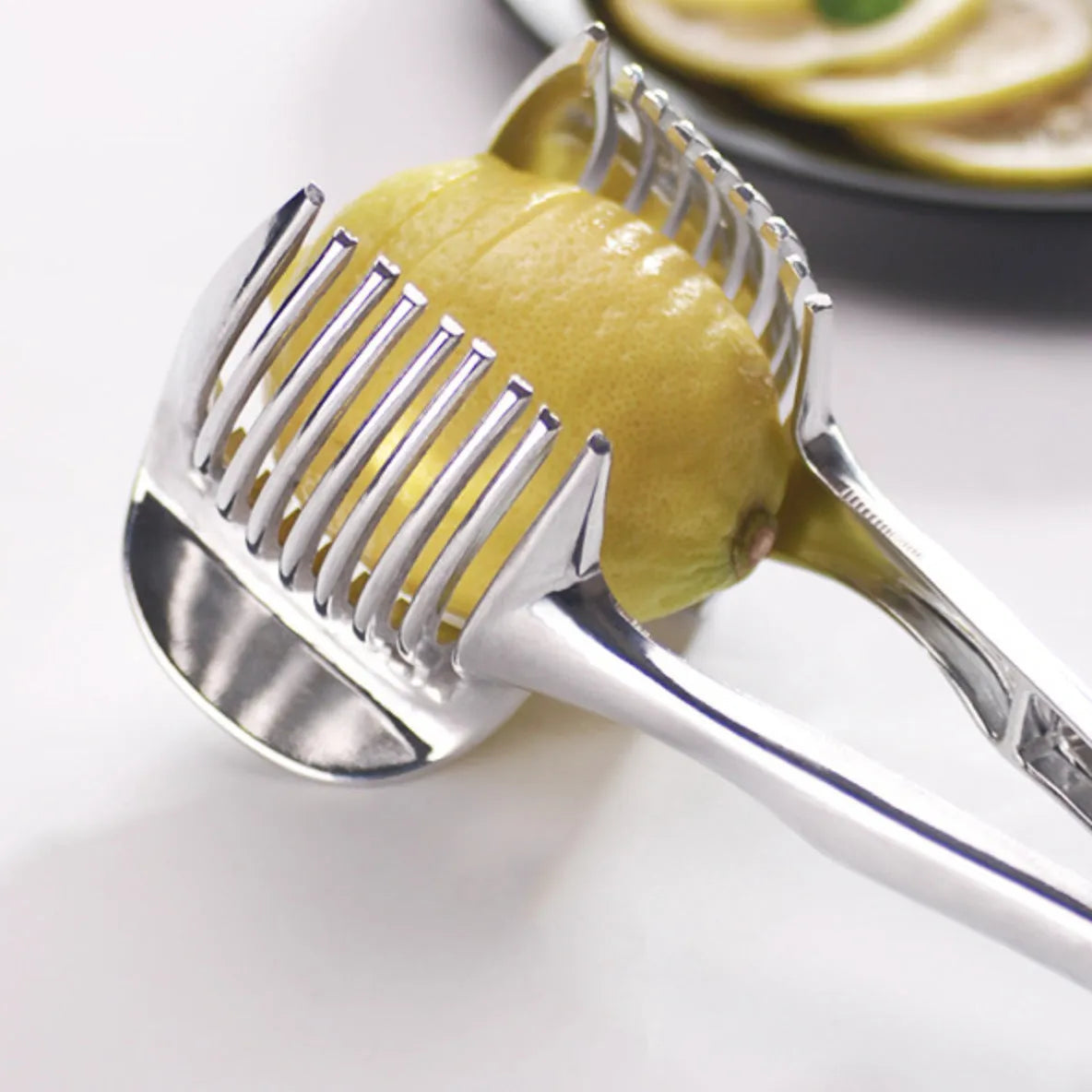 Silver plastic lemon slicer kitchen gadget on a cutting board