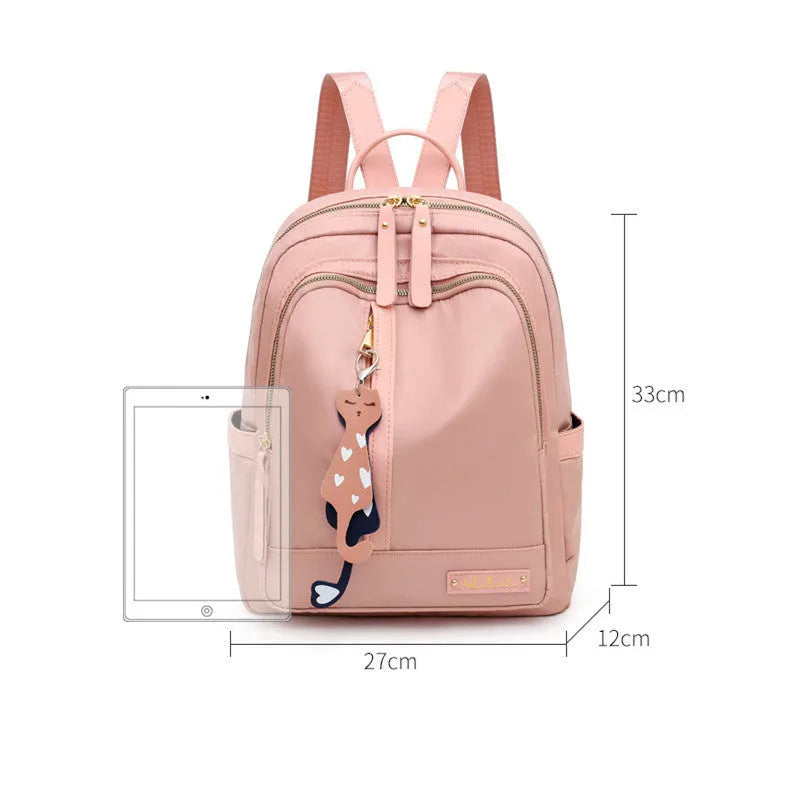 Women's casual nylon backpack in black or pink with square shape, showing external pocket and double straps.