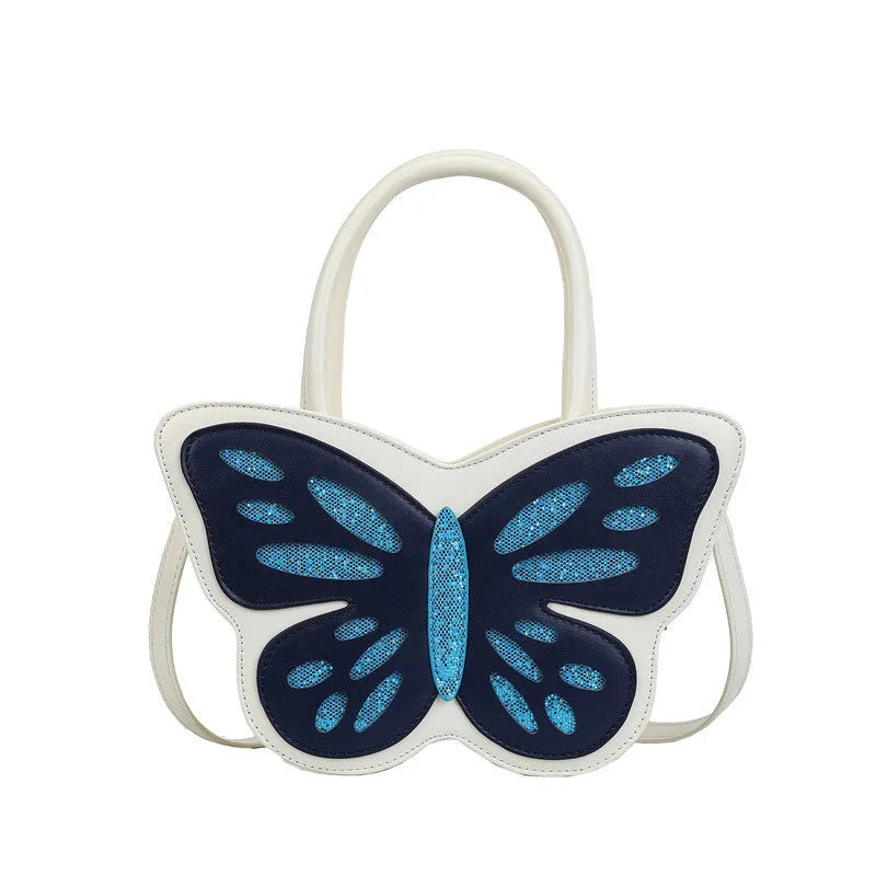 White square women's crossbody bag made of PU leather with contrast colour trim on a table.