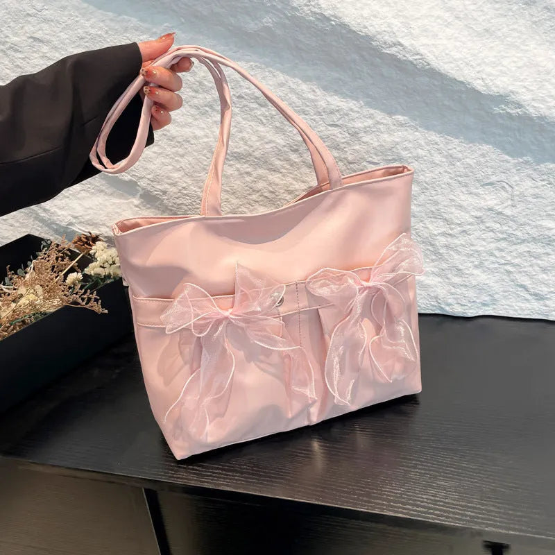College style bow tote bag in black or pink with large capacity and internal zipper compartment