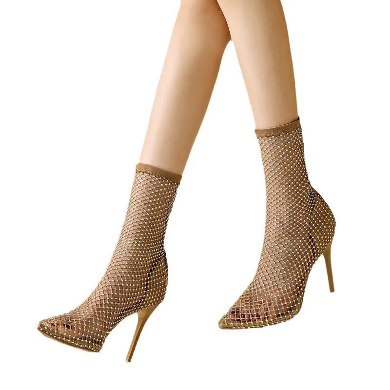 Gold women's stiletto sandals with mesh upper and pointed toe on a rubber sole.