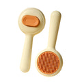 Green and yellow cat brush with stainless steel teeth and non-slip handle