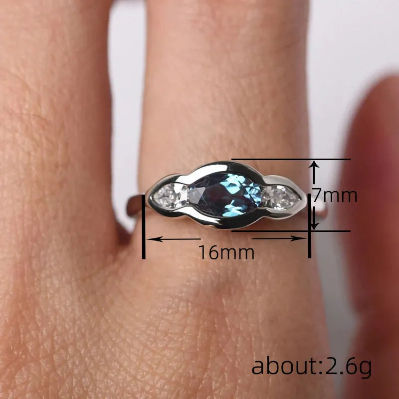 Women's geometric ellipse ring with inlaid zircon stones in white gold tone finish on finger