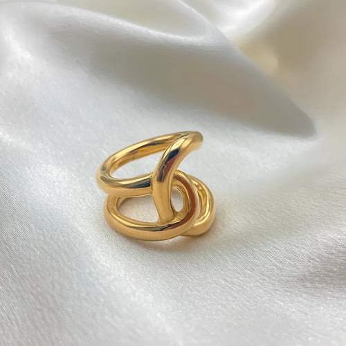 Women's stainless steel adjustable opening ring with a geometric knot design in gold colour.