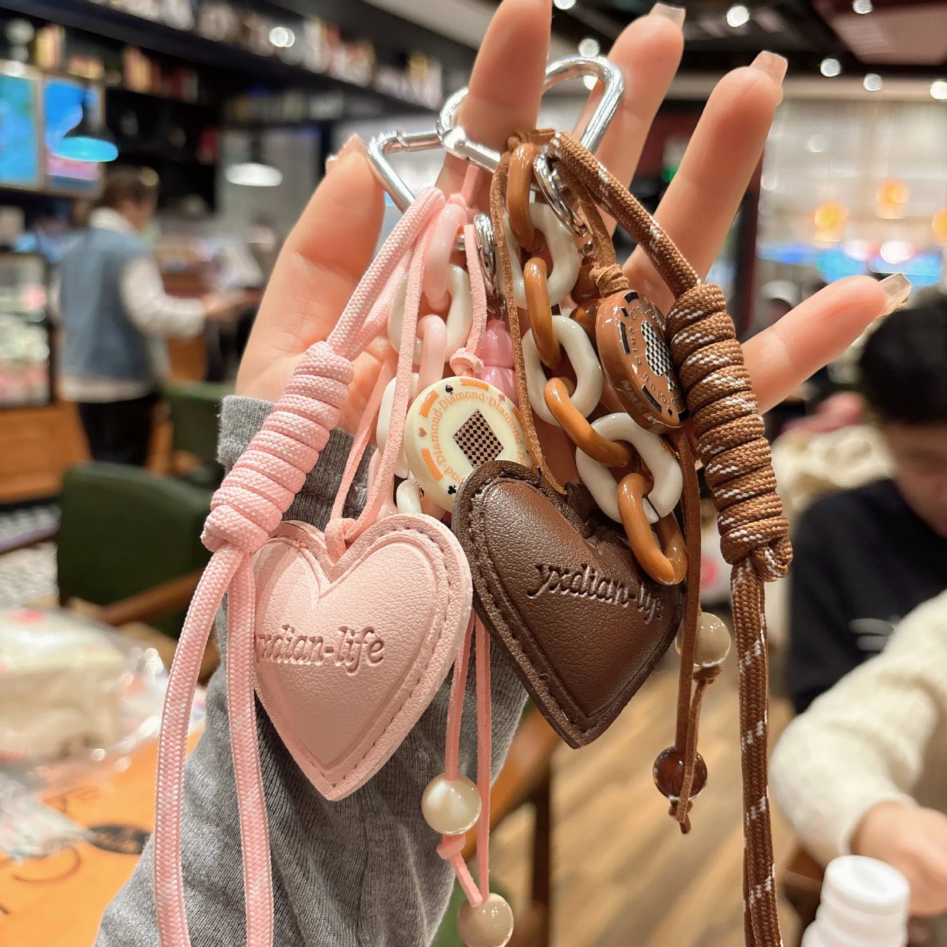Leather heart-shaped and small gourd pendant keychain with woven rope loop, available in brown, black, pink, red