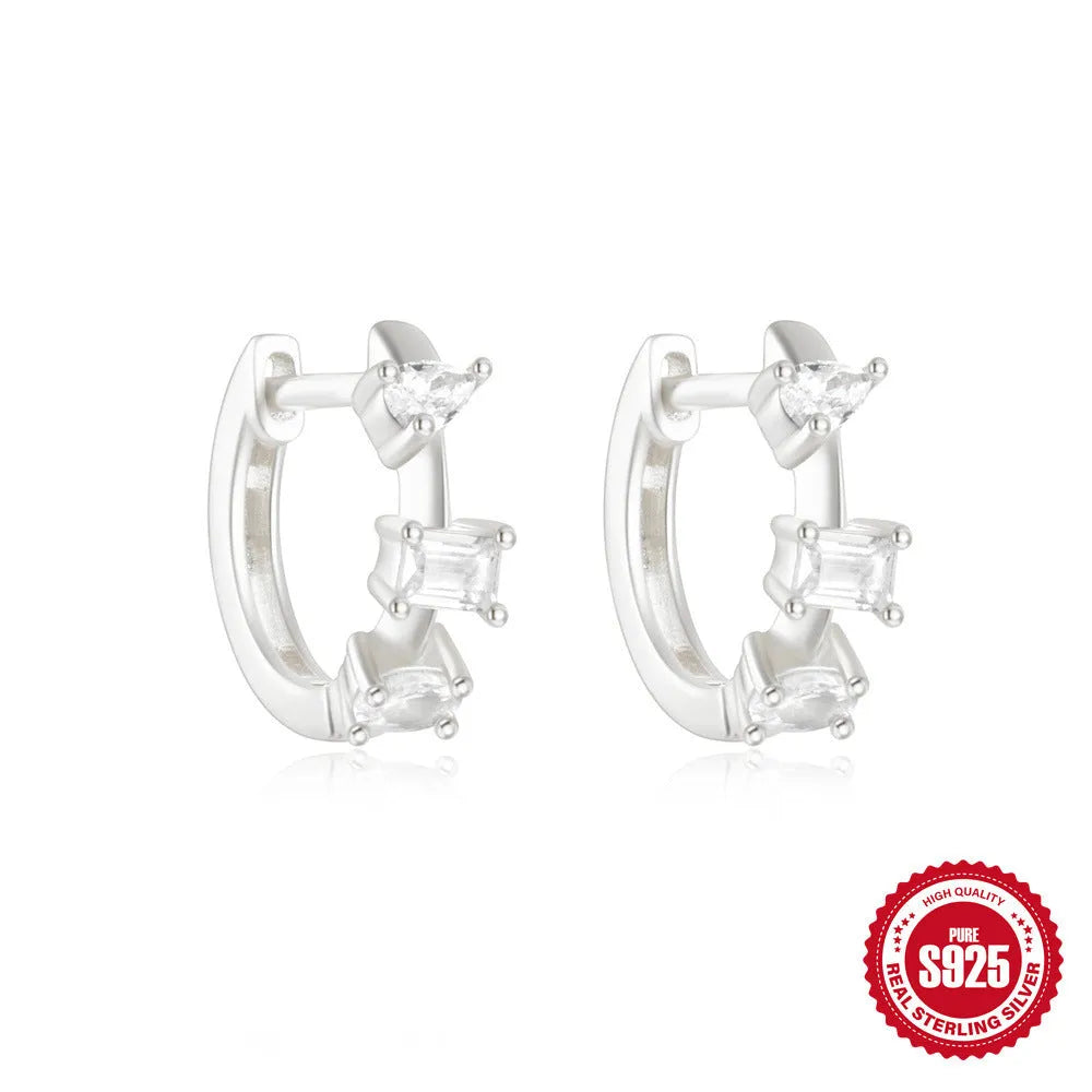Small round geometric sterling silver stud earrings in gold and silver electroplated finishes.