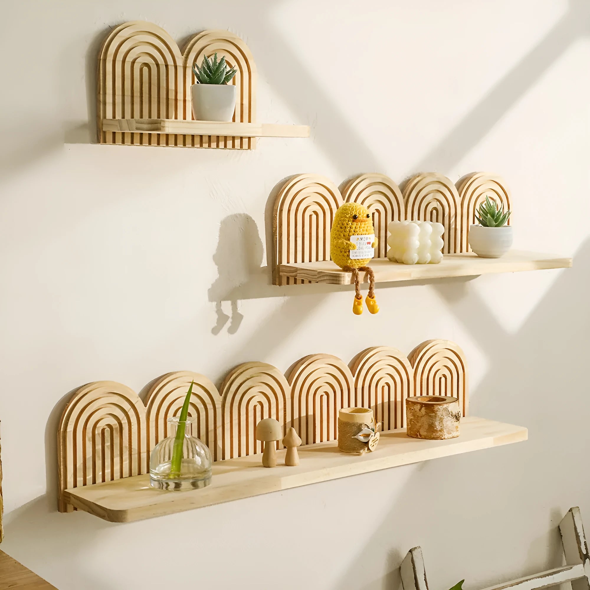 Solid wood multi-tiered wall rack holding several potted plants.