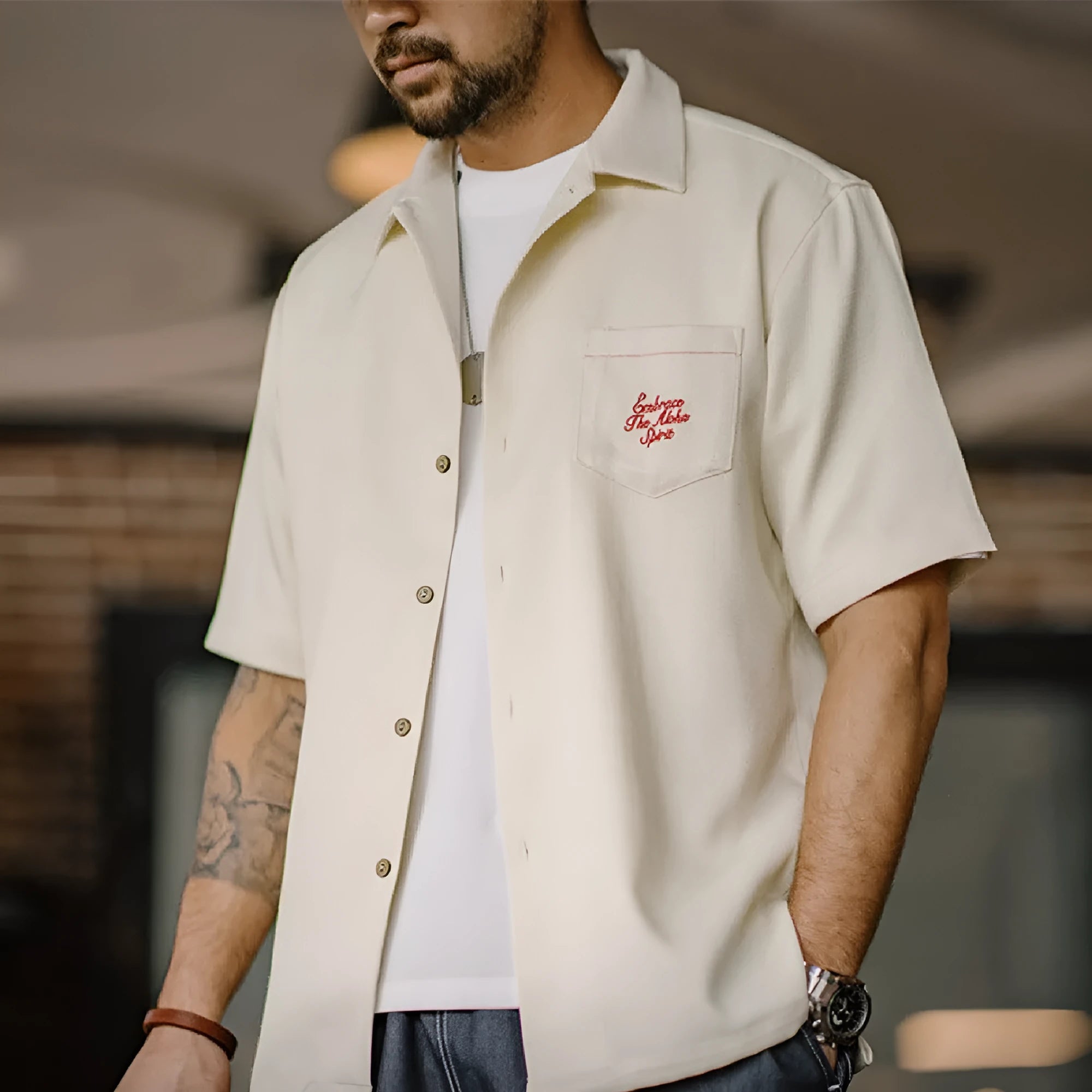 Light apricot men's short sleeve shirt with a bamboo floral pattern and a Cuban collar.