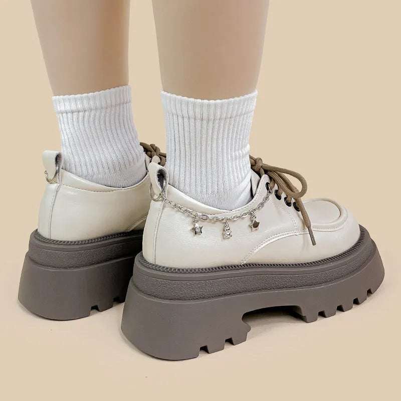 White women's platform Mary Jane shoes with a round toe, chunky high heel, and front lace-up detail.