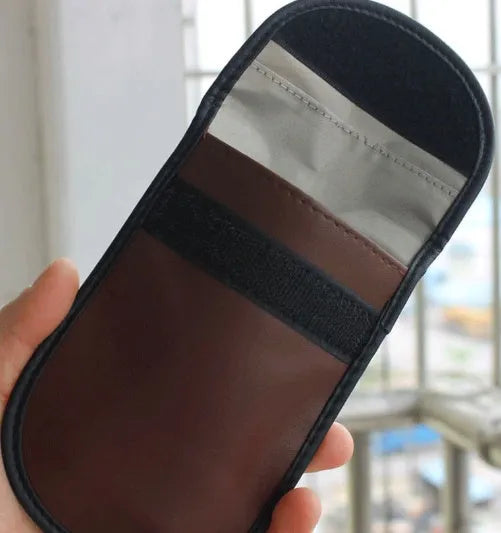 Black microfiber Faraday cage car key signal blocker case measuring 13.5 by 9.5 centimetres.