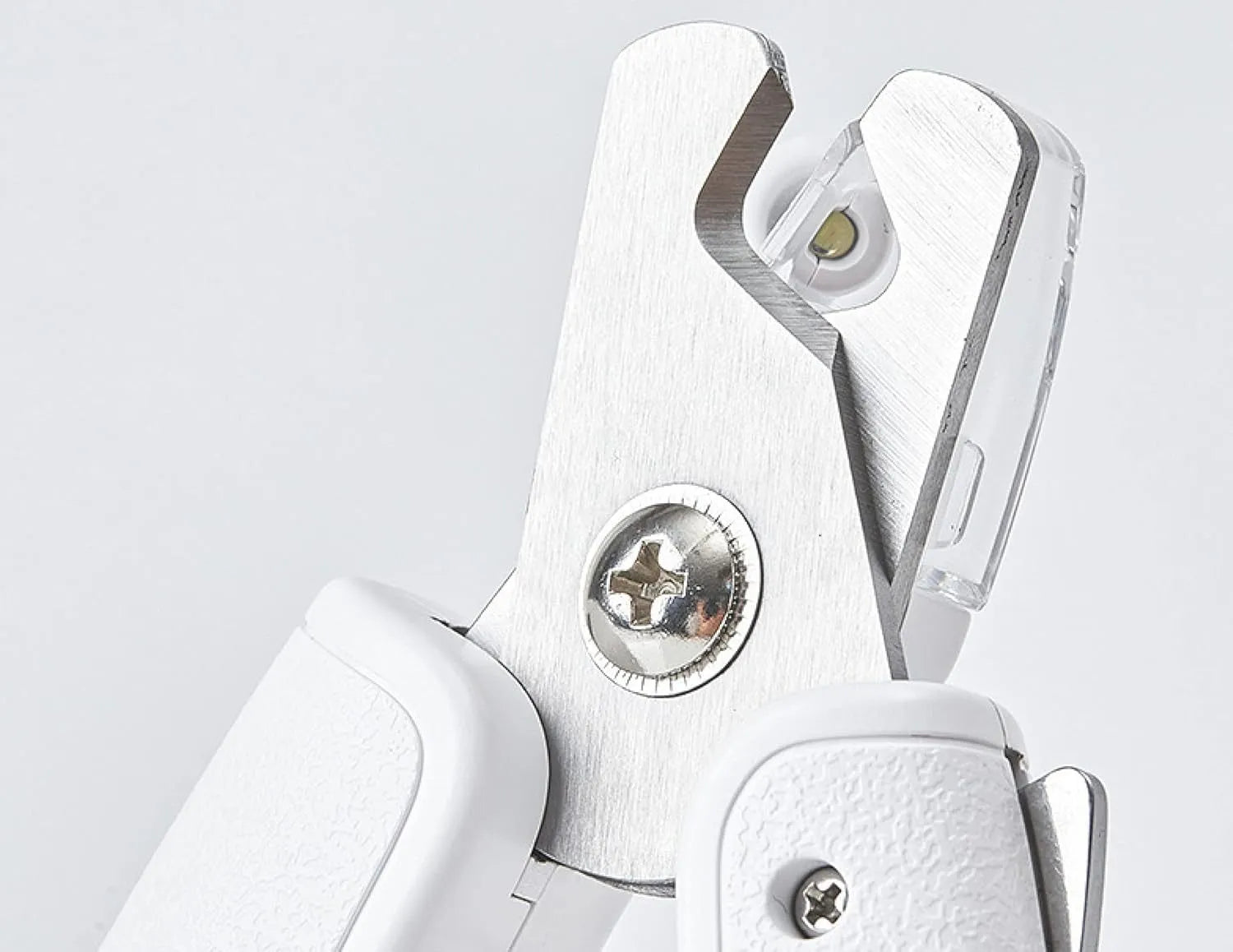 White pet nail clippers with LED light and a transparent anti-splash guard, shown with a nail file.