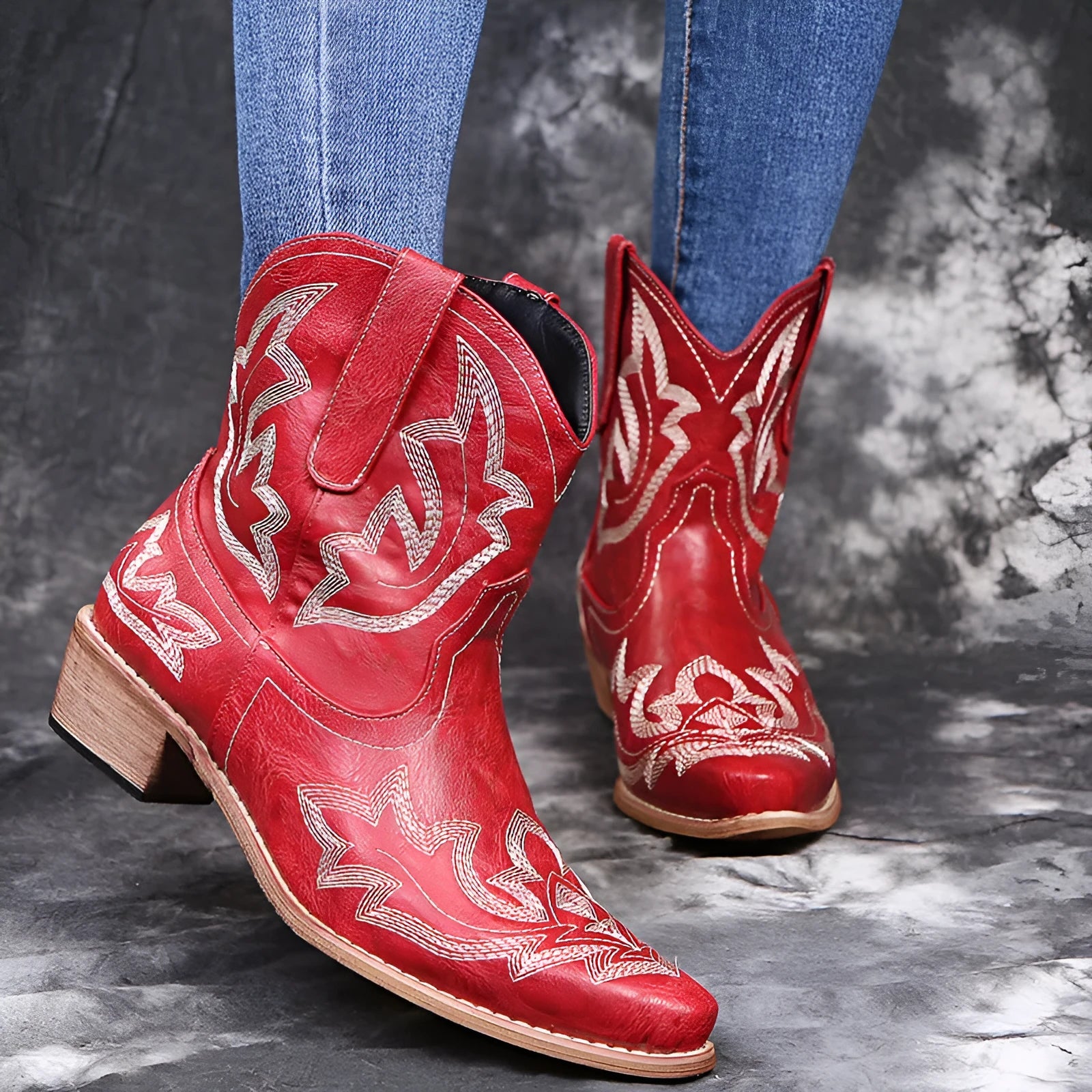 Blue women's cowboy boots with embroidery on the shaft and a low wedge heel.