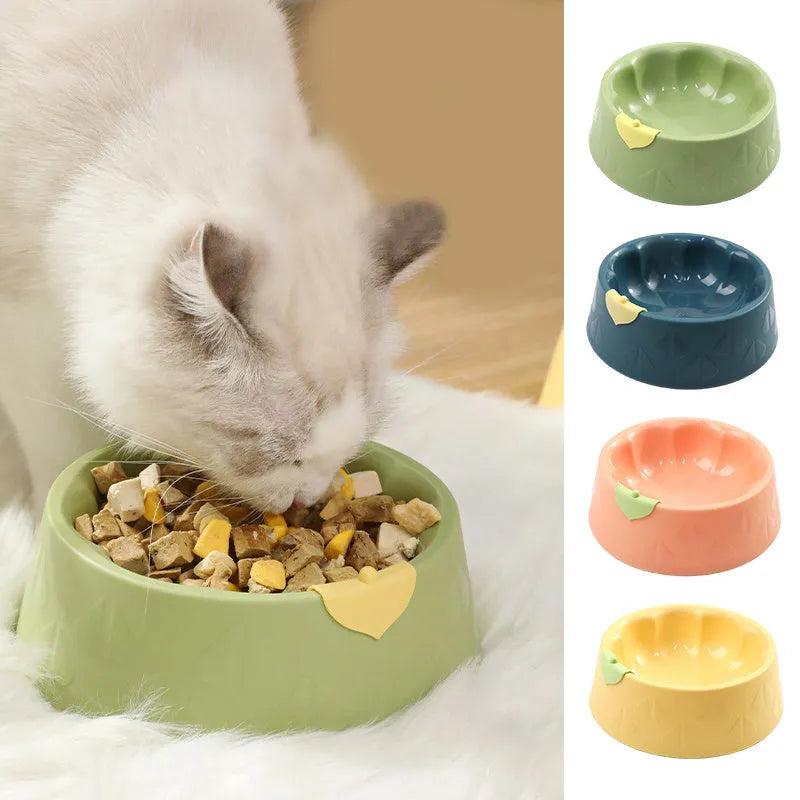 Green plastic double pet bowl for dog and cat food and water on a white surface