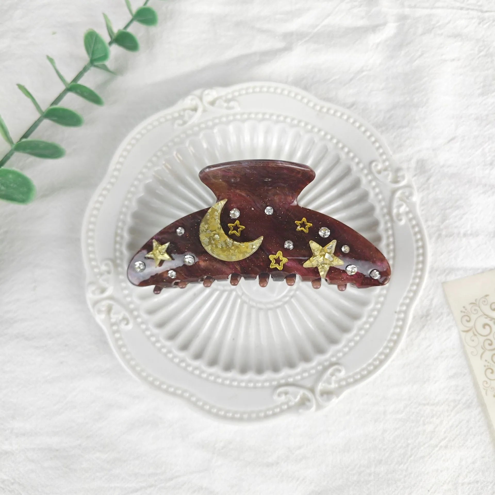 Oversized women's barrette with star moon starry sky pattern in sky blue colour.