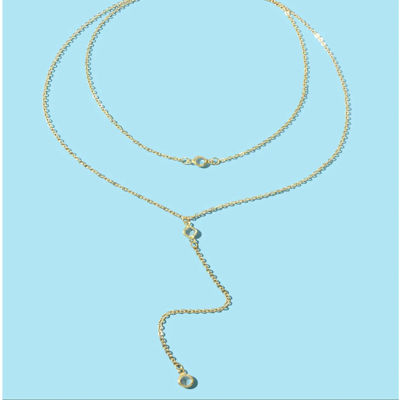 Alloy O-ring chain necklace with geometric pendant in gold finish on female neckline
