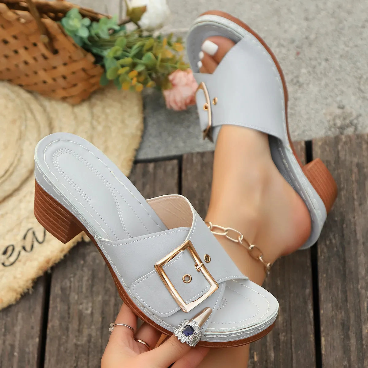 Women's black retro slippers with a chunky block heel and silver metal buckle closure