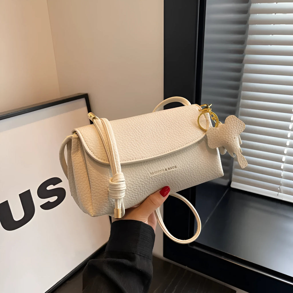 Soft PU small shoulder bag in khaki with pillow silhouette and sewing thread detail, 21cm wide.