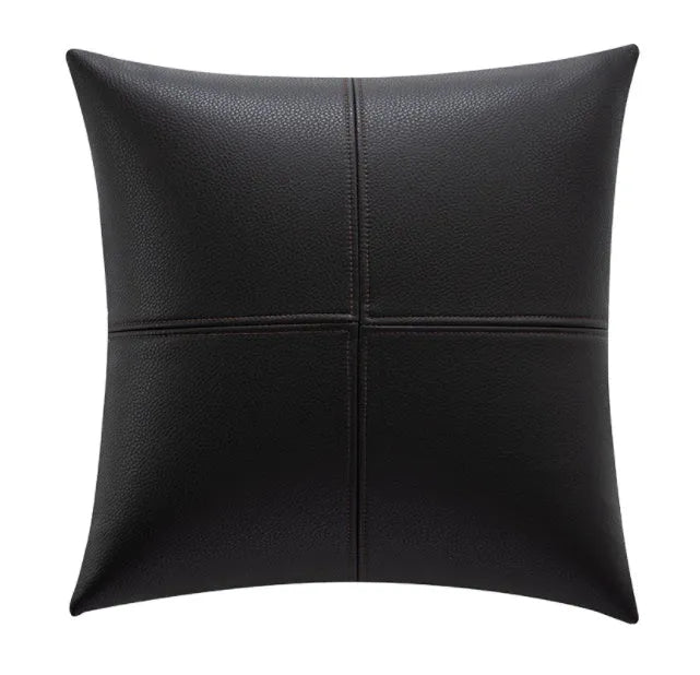 Soft cowhide leather pillow cover in a solid colour on a sofa.