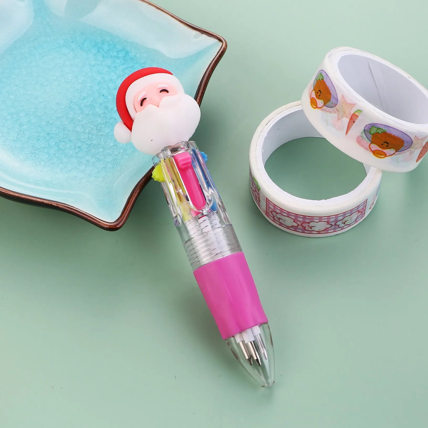 Compact 11cm Christmas-themed press-action ballpoint pen with festive designs.