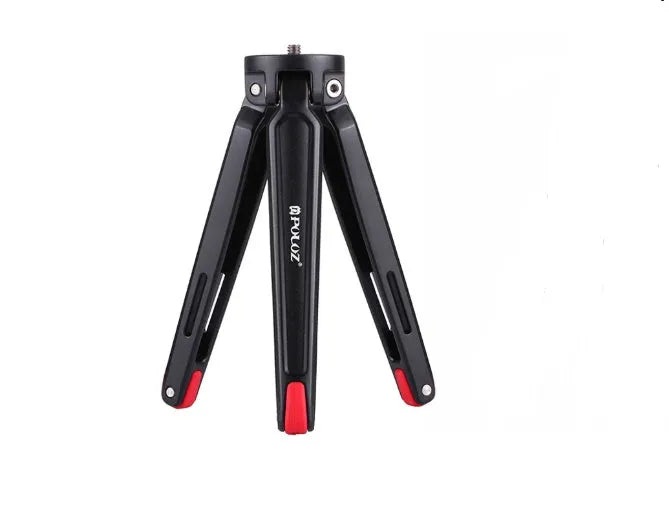 Metal mini tripod with non-slip rubber feet, 15cm max height, black, on uneven outdoor surface